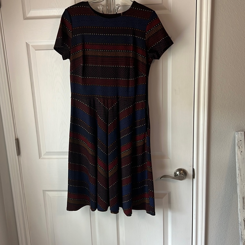 Colorful pattern dress half top is stripped horizontally and bottom is angled.